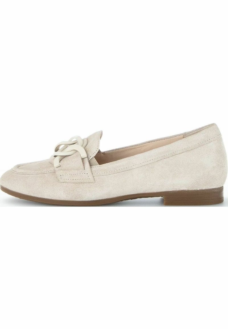 Beige suede loafers with a rounded toe, featuring a decorative lacing detail and a low brown heel. Smooth texture and minimal design.
