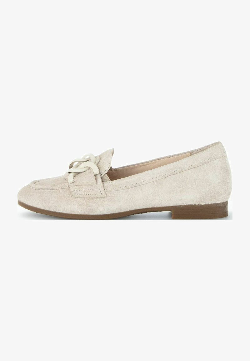 Beige suede loafers with a rounded toe, featuring a decorative lacing detail and a low brown heel. Smooth texture and minimal design.