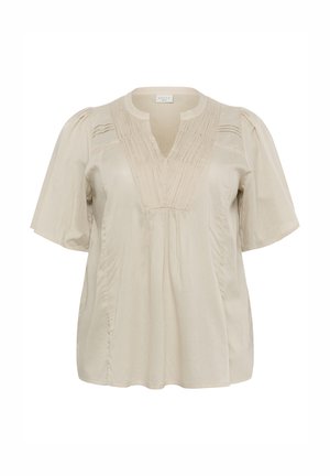 Rövid ujjú bézs blúz V-nyakkal, textúrázott részletekkel és redőkkel a mellkason. Könnyű, áramló anyagból készült.