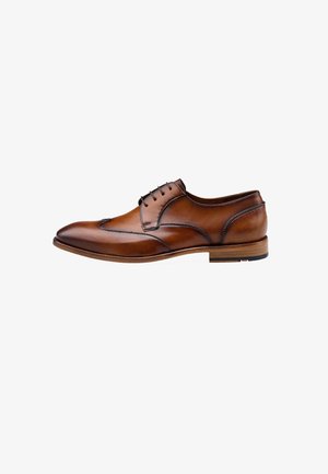 Scarpa da uomo in pelle marrone con punta arrotondata, dettagli wingtip e cuciture chiare a contrasto. Presenta un tacco effetto legno e design con stringhe.