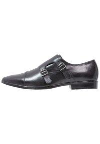 Chaussure de ville pour homme en cuir noir avec un bout pointu, double boucle de monk, et boucles en métal argenté, présentée de l'extérieur.