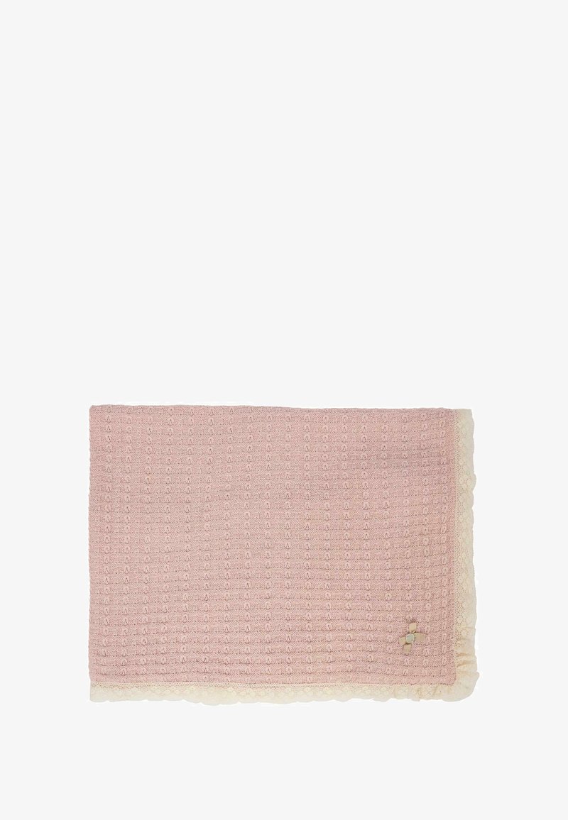 Różowy, dziany koc z teksturowanym wzorem, z falbaniastym brzegiem w kremowym kolorze. Mały element dekoracyjny w rogu.