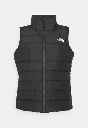 Gilet puffer senza maniche nero con colletto alto, texture trapuntata, zip centrale e logo bianco in alto a sinistra.