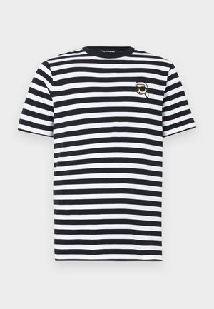 T-shirt às riscas pretas e brancas feita de algodão; apresenta um pequeno logótipo bordado no peito. Mangas curtas e design com gola redonda.