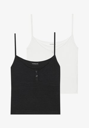 Camisetas sin mangas en blanco y negro con tirantes finos. La camiseta negra presenta un detalle de botones y un escote con forma de ondas; ambas tienen una textura suave y lisa.