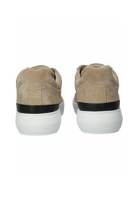 Beige suede sneakers with a rounded toe, low ankle, and contrasting black heel counter. White rubber sole with a textured finish.