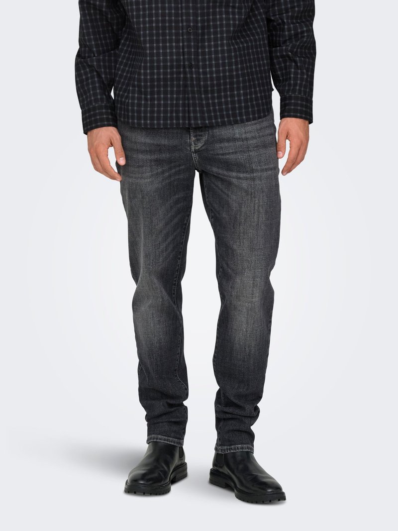 Dark grey denim jeans with a straight fit, subtle whiskering, and five-pocket design paired with a black checkered long-sleeve shirt.
