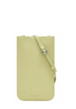 Light yellow leather crossbody phone bag with a smooth texture, featuring an adjustable strap and silver hardware accents.