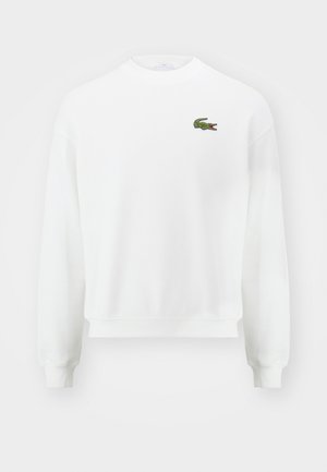 Weißes Sweatshirt mit Rundhalsausschnitt, langen Ärmeln und kleinem grünem Krokodil-Logo auf der linken Brust.