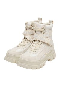Beige high-top boots made of textile and rubber. Features a thick sole with a textured grip and adjustable straps with brand lettering.