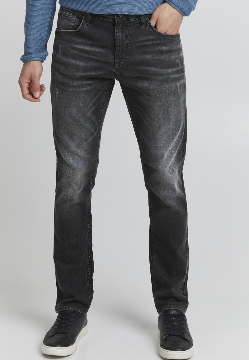 Mustad denim püksid slim fit lõikega, millel on veidi kulumist ja kulumise jälgi ees, tikandiga detailid ja viie tasku disain.