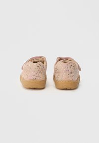 Pink suede shoes with glittery accents, round shape, Velcro strap, and flexible rubber sole. Pattern features reflective dots across the sides.