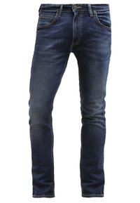 Jean slim bleu foncé avec bouton et fermeture éclair à l'avant, design à cinq poches et détails délavés sur les cuisses et les genoux.