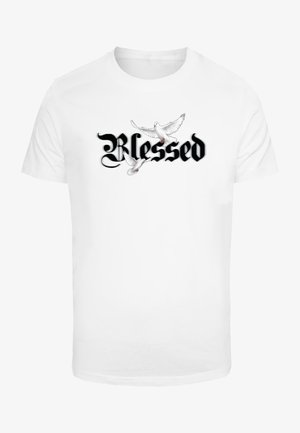 White cotton t-shirt featuring the word "Blessed" in black script. Two illustrated white doves are shown flying above the text.