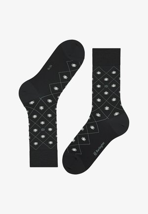 Black cotton socks featuring a diamond pattern with small white camera icons, finished with contrasting gray stitching and a general logo at the sole.