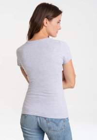 Light gray short-sleeve t-shirt with a round neckline, made of ribbed fabric, fitted design, shown from the back against a plain background.