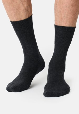 Dunkelgraue Knöchelsocken aus weichem Material, mit geripptem Bündchen und glatter Oberfläche. Standard-Sockenform ohne sichtbare Muster.