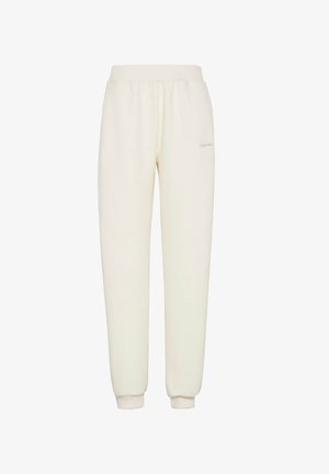 Pantalones deportivos de color crema con textura acanalada, cintura elástica y puños, con un pequeño detalle de logo en el muslo.