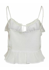 White tank top with thin adjustable straps, smocked bodice, scalloped lace trim, and a ruffled hem. Smooth fabric with a soft texture.