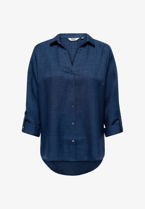 Tamsiai mėlyna ilgomis rankovėmis marškiniai su atvartais, apvyniotais rankogaliais, apykakle ir išlenkta apačia, priekis baltame fone.