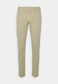 Beige puuvillachinohousut, slim fit -mallia, joissa on etutaskut, nappikiinnitys ja vyölenkit. Tasainen pinta, jossa on kevyet ompeluyksityiskohdat.