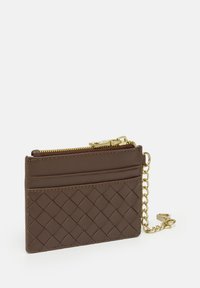 Brown leather cardholder with woven texture, gold zip closure, three card slots, and a chain attachment. Compact and functional design.