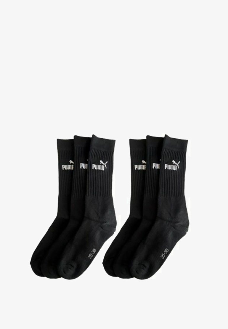 Six black Puma crew socks, ribbed upper with white Puma logo and size markings on the sole, arranged in two groups of three.