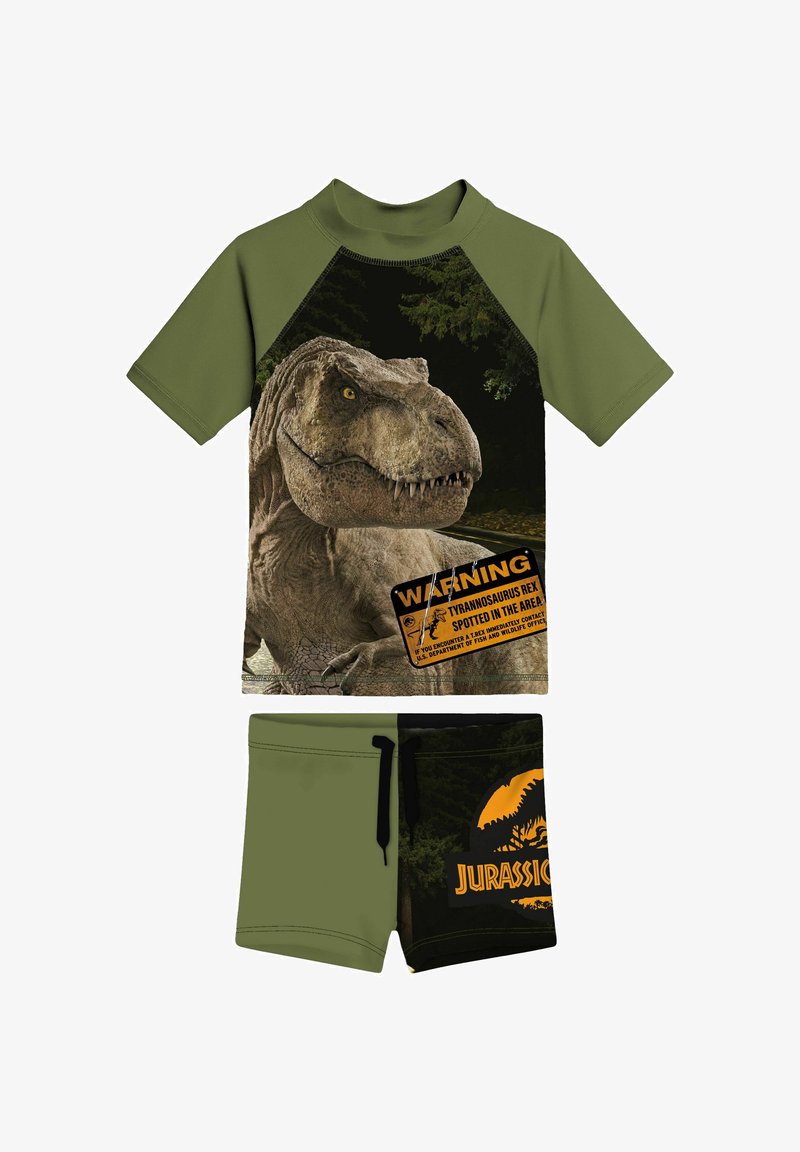 Completo verde e nero per bambini con grafica di T. rex e scritta "Attenzione Tyrannosaurus Rex avvistato" sulla maglietta, pantaloncini neri con logo Jurassic Park.