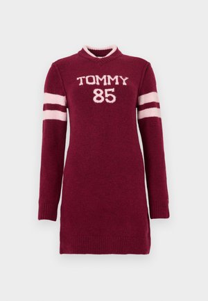 Maroon knitted dress with long sleeves, v-neck, white collar, and "TOMMY 85" embroidered in light pink on the front and striped accents on sleeves.