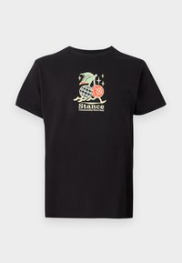 Black cotton t-shirt featuring a colorful graphic print with a pineapple and cherries, text reads "Stance Community Run Club." Short sleeves.