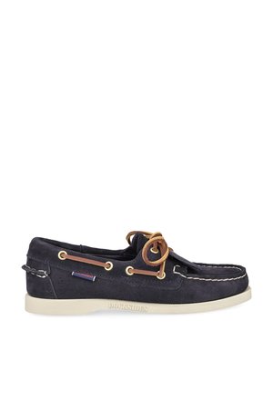 Navy blue suede boat shoe with white stitching, brown leather laces, brass eyelets, and white rubber sole labeled "DOCKSIDES."