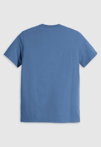 Short-sleeve t-shirt in soft, solid blue cotton. Round crew neckline, relaxed fit, and seamless back design. No patterns or accents.