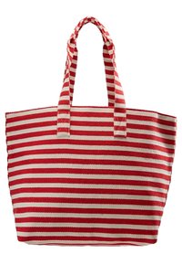 Sac fourre-tout rayé rouge et blanc en tissu, avec deux poignées robustes et une forme rectangulaire. Surface texturée avec de larges rayures.