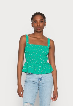 Top peplum floral verde com decote quadrado e alças largas. Apresenta uma textura veneziana e pequenos padrões de flores em tecido leve.