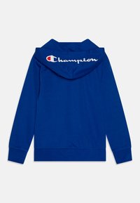 Sweatshirt à capuche bleu avec un logo en texte blanc au dos. Doté de manches longues et d'une poche kangourou. Fabriqué en tissu doux.