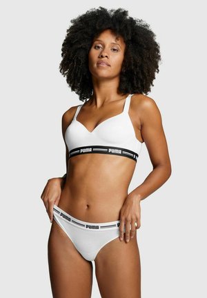 White bra and thong set, featuring a supportive design, soft fabric, and an elastic band with a black "PUMA" logo.