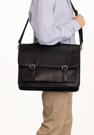 Black leather messenger bag with a flap, metal buckles, adjustable shoulder strap, and a smooth texture. Structured design with no visible logos.