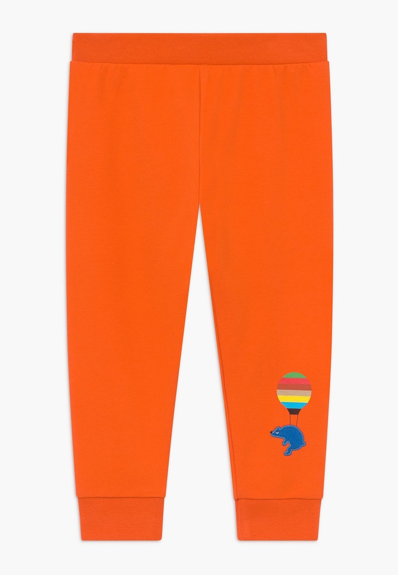 Pantalon d'enfant orange vif avec ceinture et poignets élastiques, ornés d'un motif coloré de montgolfière et d'un ours bleu près de la cheville gauche.