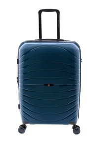 Maleta rígida de color azul oscuro con superficie con patrón de olas, asa retráctil y cuatro ruedas multidireccionales para facilitar la movilidad.