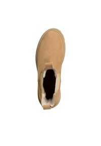 Bottine en daim beige avec des panneaux élastiques sur les côtés, bout arrondi et doublure douce. Comprend une petite languette à l'arrière pour un enfilage facile.