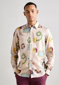 Long-sleeve shirt in light pink fabric featuring a colorful floral and abstract pattern. Notable accents include a multi-colored collar and buttons.