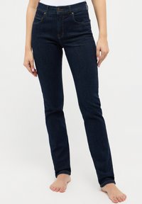 Mørkeblå denim skinny jeans med høy midje, synlige frontlommer og orange sømdetaljer. Jevn tekstur, tettsittende design.