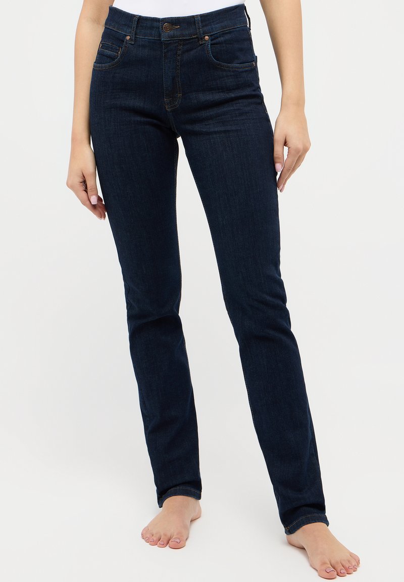 Mørkeblå denim skinny jeans med høy midje, synlige frontlommer og orange sømdetaljer. Jevn tekstur, tettsittende design.