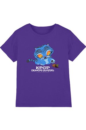 Purple t-shirt featuring a blue cartoon cat with large yellow eyes playing with a fallen plant pot. Text reads "KPOP Demon Hunters."