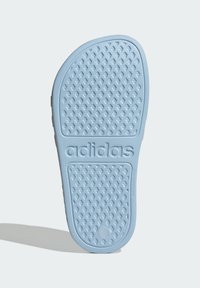 Light blue rubber outsole featuring a textured, diamond pattern, with embossed "adidas" logo near the heel for grip and stability.