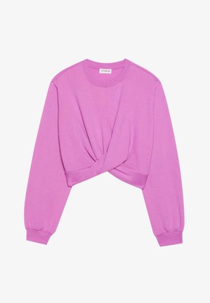 Lilla lühike spordijakk, millel on keeratud esiosa. Omab pikki varrukasid ja ümmargust kaelust, valmistatud pehmest puuvillasegusest materjalist.