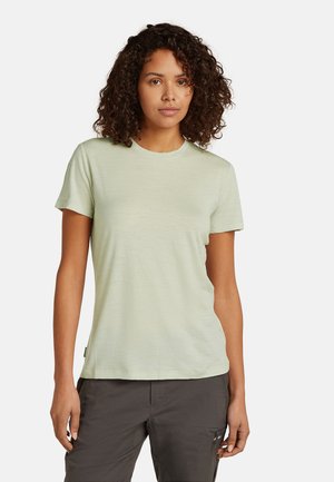 Light green short-sleeve t-shirt with a round neckline, smooth texture, and a relaxed fit. Tag visible on left side near hem.
