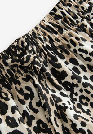 Kangas leopardi kuvioinnilla beige ja musta värimaailmassa, jossa on joustava vyötärö ja naru-yksityiskohta. Pehmeä kangas ja virtaava muotoilu.