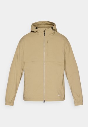 Beige lightweight jacket with a zip front, adjustable hood, and elastic cuffs. Features a chest pocket and minimal branding.