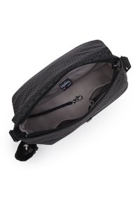 Black textured handbag with a zipper closure, featuring a light interior and a detachable strap. Includes a pom-pom keychain detail.
